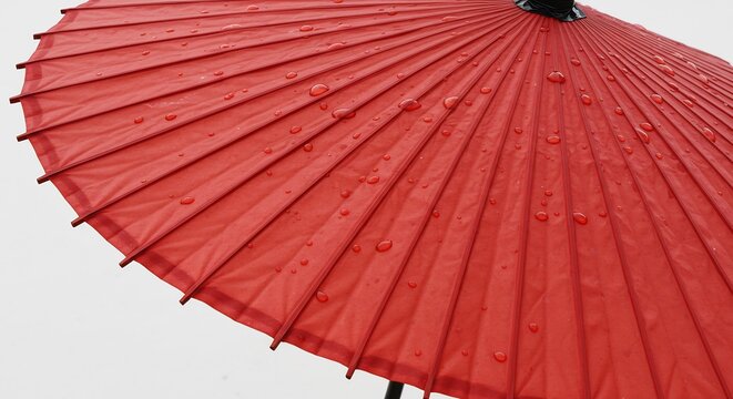 Red paper umbrella glistening softly under gentle rain. AI Generated