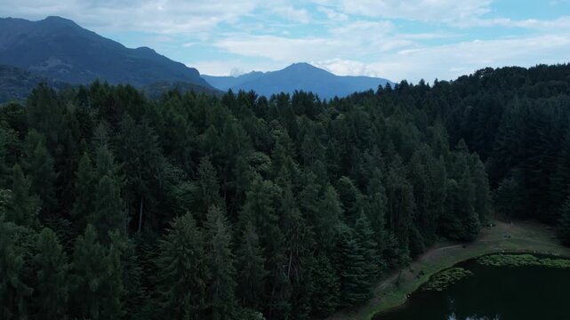 Aerial Scenic view Meugliano Lake in Val di Chy or Valchiusella, near Brosso town, Ivrea, Italy Morainic Amphitheatre geological formation static drone shot