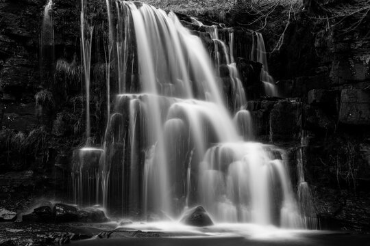 Black and white long exposure of a cascading waterfall - Powered by Adobe