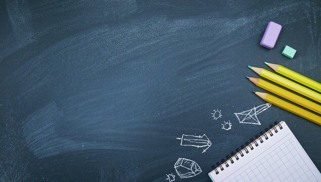 back to school. School chalkboard with pencils erasers notebook and chalk drawings