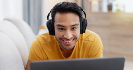 Relax, laptop and headphones with man on sofa for streaming service, smile and film. Movie...