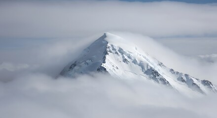 Snowy mountain range above clouds
