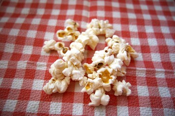 Close-up of fresh popcorn served on a red checkered napkin with copy space.