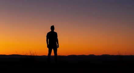 Fototapeta premium Silhouette of a person against a twilight sky