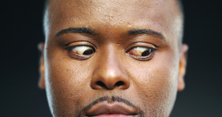 Nervous, anxiety and eyes of black man in studio for stress, fear and paranoid for mental health...