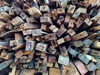 A chaotic pile of old, weathered wooden blocks and scraps, perfect for showcasing textures,...