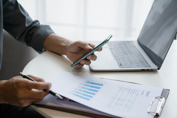 Businessman Calculating Revenue and Planning Business Strategy at Office