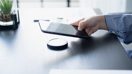 Woman using wireless charger charge smartphone