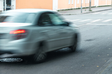 A car is driving down a street