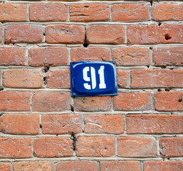 A blue and white sign with the number 91 on it
