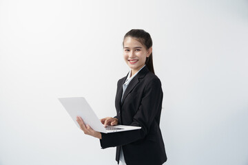 Portrait of Asian businesswoman standing holding and using laptop in white studio background