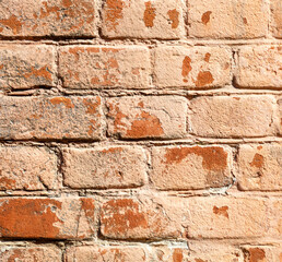 A brick wall with a few spots of paint on it