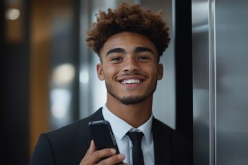 Smiling young male businessman standing in an office space, calling an elevator and using a mobile phone, depicting a busy and efficient professional at work, Generative AI