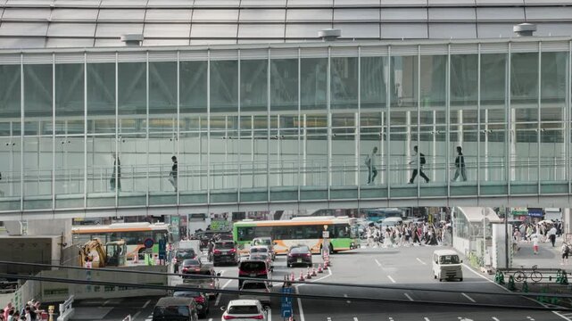 Tokyo Scene : Elevated Pedestrian Walkway. Road in front of the Station below is Bustling with Buses from the Terminal, Motorcade and Jams at the Intersection  |  Shibuya Station, Tokyo, Japan