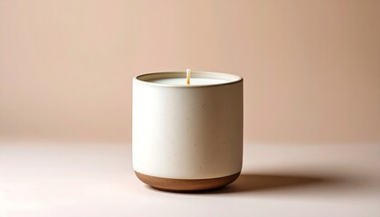 Elegant ceramic candle with warm neutral background creates serene home ambiance