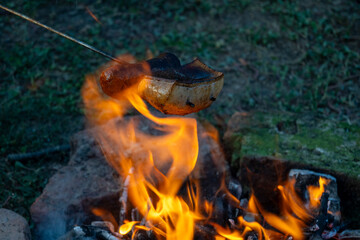 Hungarian traditional campfire cooking - bacon on skewer