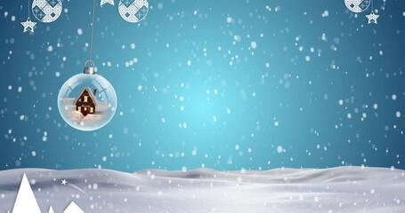 Animation of snow falling over christmas snow globe and baubles in winter scenery on blue background - Powered by Adobe