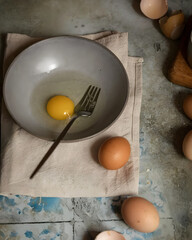 Raw Egg in Bowl with Fork – Minimal Moody Food Photography for Cooking Concept