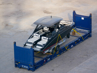 Motor yacht fastened with slings and supports on flat rack container, prepared for international...