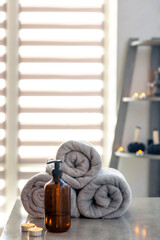 Cozy spa corner with candles and towels