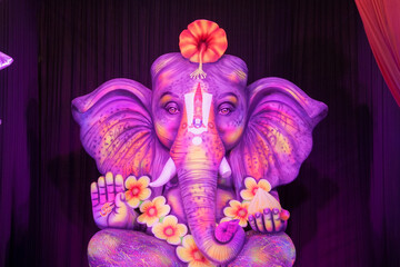 Ganesh idol with floral decoration, Vibrant Ganesha statue with flowers, Lord Ganesha with mouse...