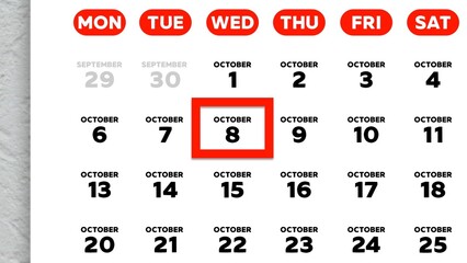 Close-up of the date October 8th marked with a red cursor on the wall calendar 2025