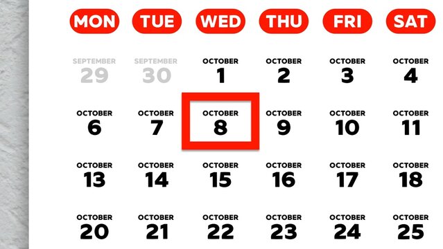 Close-up of the date October 8th marked with a red cursor on the wall calendar 2025