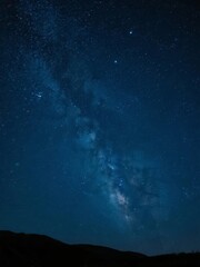 Fototapeta premium Starry Night Sky with the Milky Way Over Silhouetted Hills