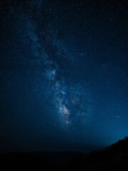 Fototapeta premium Starry Night Sky with the Milky Way Galaxy Over Silhouetted Hills