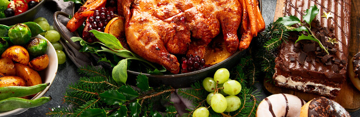 Festive dinner table with roasted chicken. Christmas family dinner.