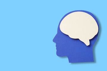 Cutout design of a head and brain on bright blue
