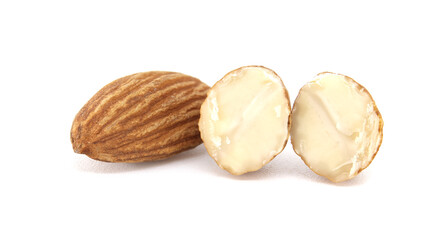 A detailed view of almonds, with a whole one and two cut-open halves against a white background.