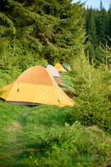 Tent in the mountains. Camping concept. Perfect for holiday leisure, outdoor activities, and a summer vacation trip.