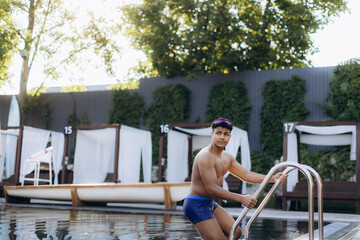Swimmer exiting pool using ladder after training session