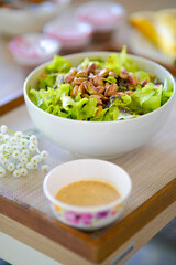 A fresh mixed vegetable salad topped with assorted nuts, beautifully prepared and ready to enjoy.