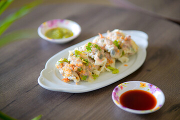 Steamed dumplings topped with crispy garlic, beautifully plated and ready to serve.