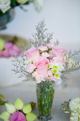 A pink flower bouquet in a vase: A beautiful arrangement of pink flowers placed in a vase. The soft pink petals create a gentle and romantic feel.
