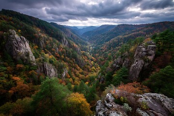 Obraz premium 1. Autumn cliffside with forests cascading down into valleys, dramatic sky above 