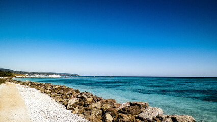 Breakwater on beach in Vada, Italy.