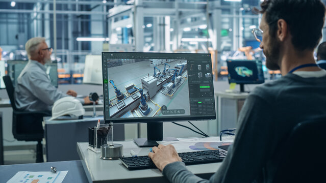 Advanced Manufacturing: Team of Engineers Collaborate on Design of Robotic 3D Assembly Line. Screen Shows Software Automated Production Process, Optimizing Industrial Facility Layout
