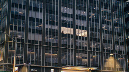 Night Shot of City Street. Skyscraper With Illuminated Office Windows. Ground Floor Businesses,...