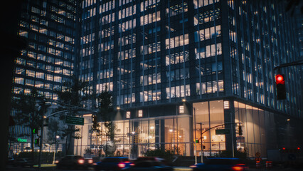 Night Shot of City Street. Skyscraper with Illuminated Office Windows. Ground Floor Businesses,...