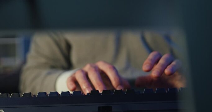 Closeup young adult male freelance developer typing write prompt AI bot app program nomad terminal coding at office night. Artificial intelligence dashboard, robotics user interface, machine learning.