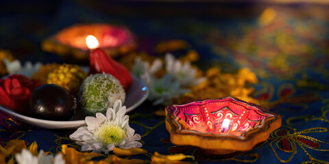 Diwali celebration with decorative sweets and candles on festive table