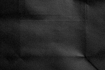 Black textured rough paper with folds and creases of geometric shapes