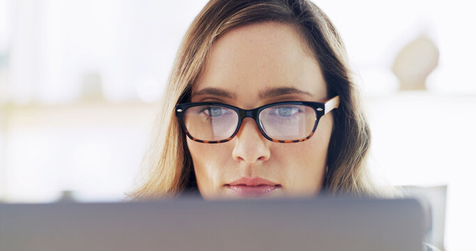 Creative, woman and reading on computer at house for research, editor feedback and proofreading. Journalist, glasses reflection and PC to review article, fact check and story report for publication