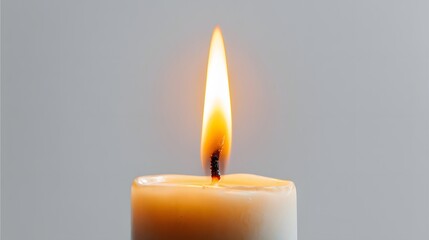 Single lit candle flame on neutral background.