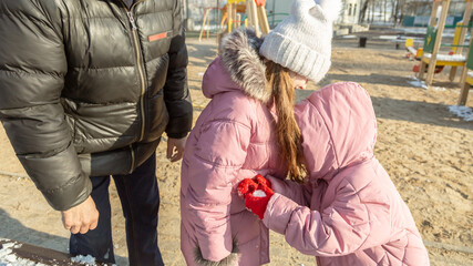 Little girl, quarreling and other crying during their walking in winter.