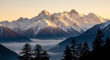 Majestic snowcapped mountain range bathed in golden sunlight at sunrise, with misty valleys below