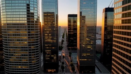Stunning golden hour cityscape with modern skyscrapers reflecting the sunset light, perfect for urban development or corporate branding visuals